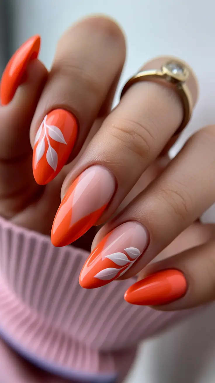 April nails ideas 2026 Orange French Inspired Almond Nails With Delicate Leaf Art